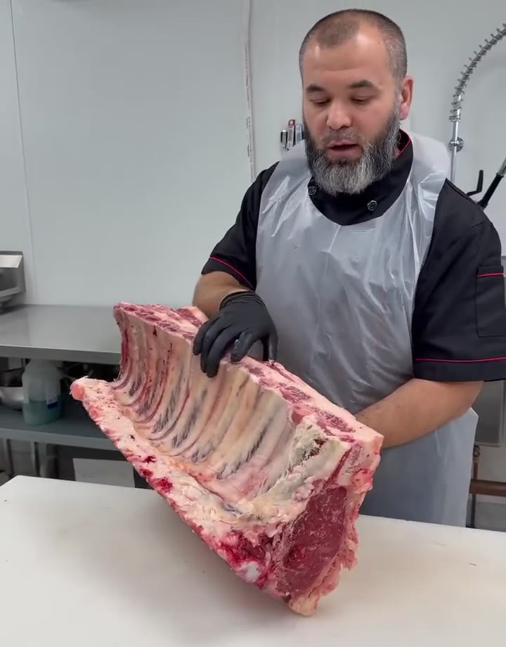 Preparing a rib cut by hand at Prime Halal Meat