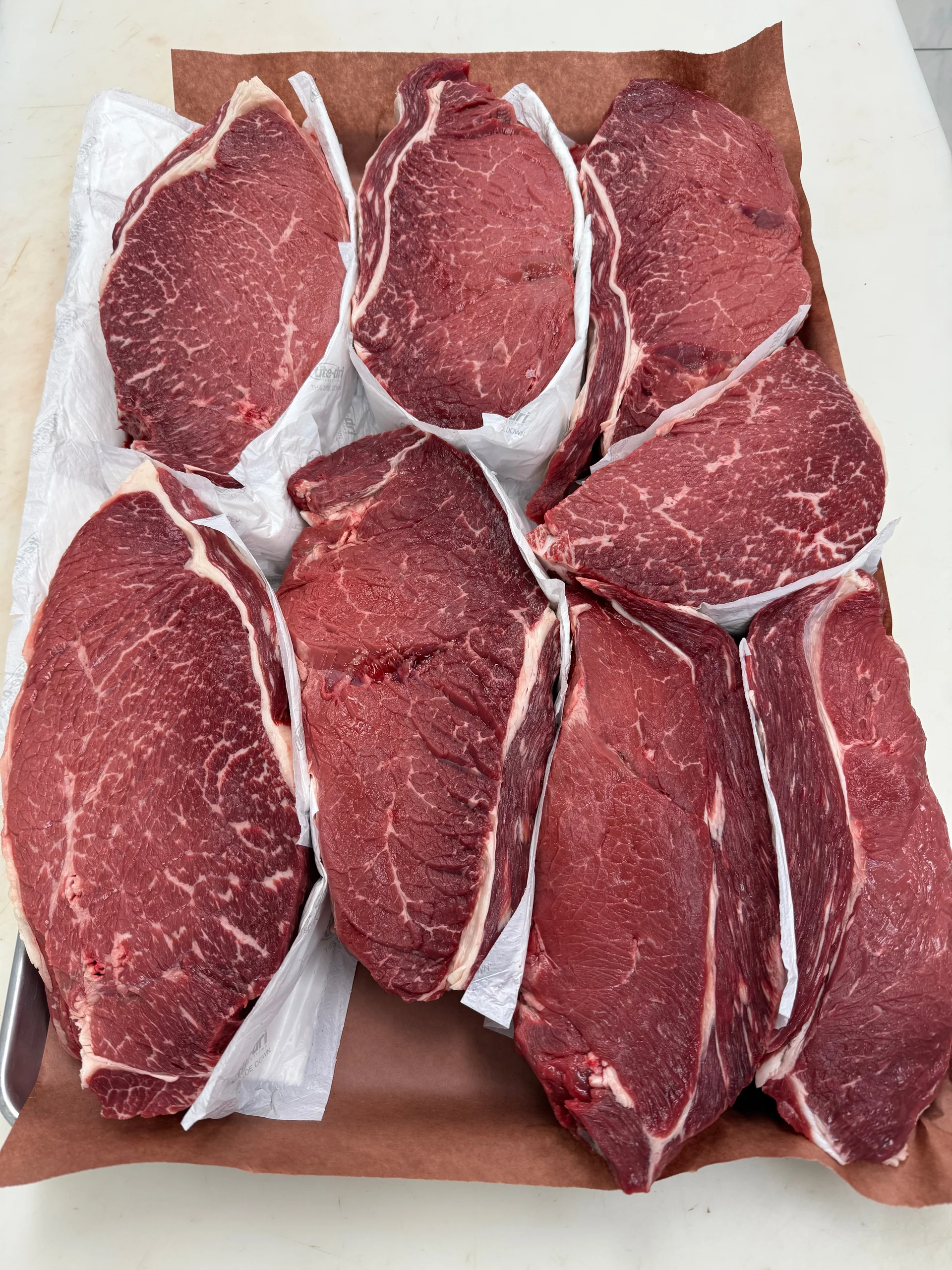 A close look at six freshly cut steaks